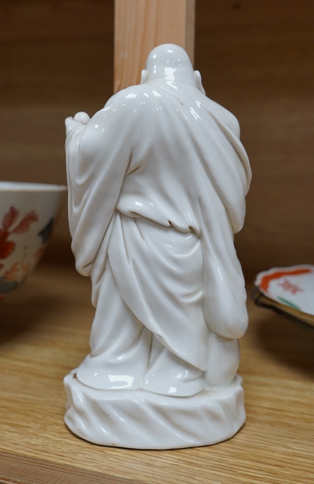 A Chinese blanc de chine figure of Budai, 18cm high. Condition - fair to good